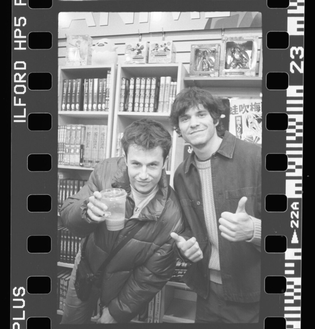   Dylan Minnette (Wallows rhythm guitarist) raises his almost empty drink to the camera while Braeden Lemasters Wallows bassist) offers two thumbs up in support. Photo courtesy of Soph Cheung //    @soph0tograph   
